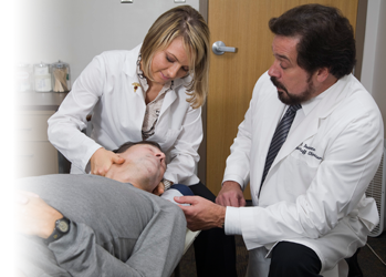 Photo of intern adjusting patient with clinician supervising