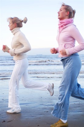 two women running on beach