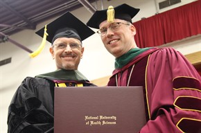 doctor stiefel presenting degree at commencement ceremony