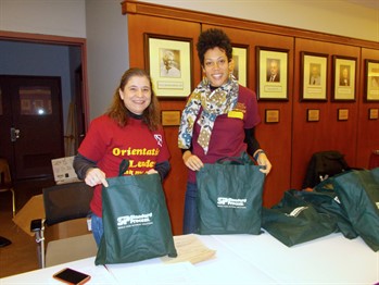 NUHS faculty holding tote bags at student orientation