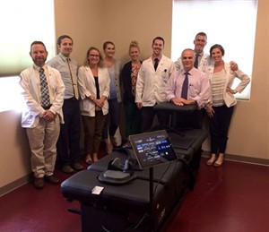 National University staff and students around loaned non-surgical decompression table