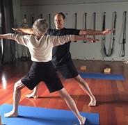 man and woman practicing yoga