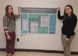 Dana Madigan, DC, and student Haley Doherty presenting informational poster