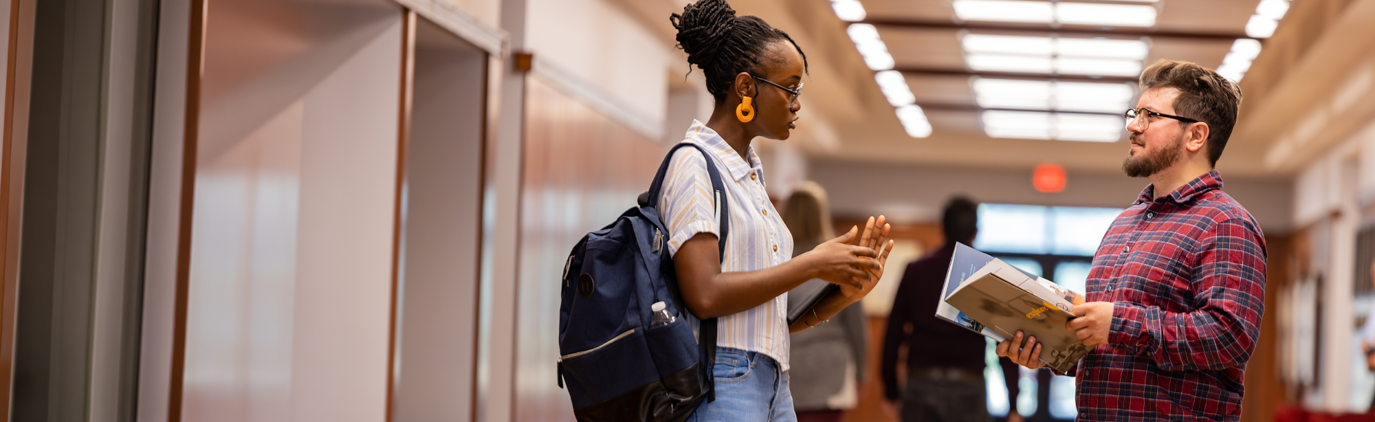 students walking inside at NUHS campus