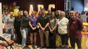 Volunteers gather for a group picture at the backpack drive.