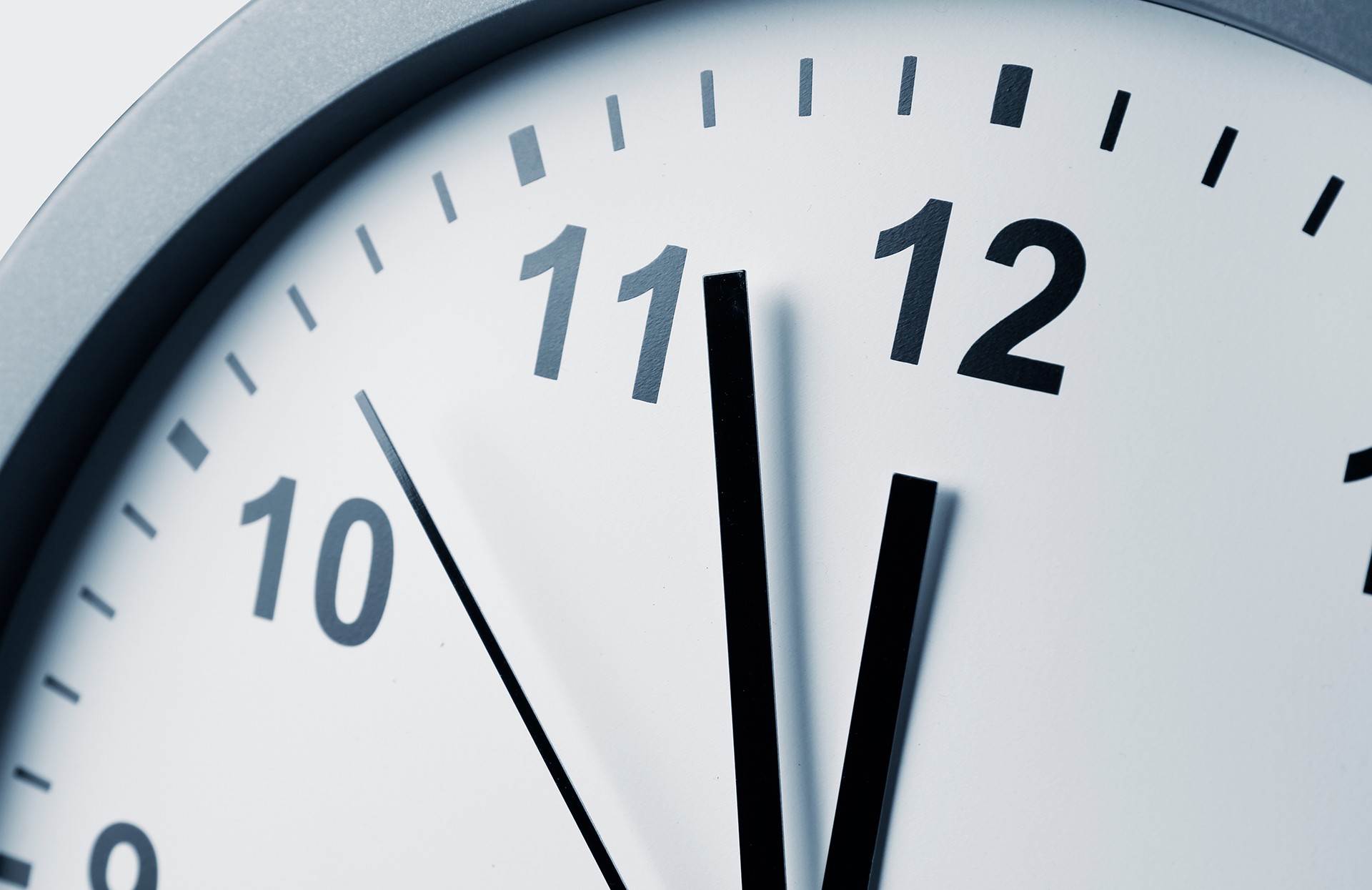 Clock face with hands at 3 minutes before 12