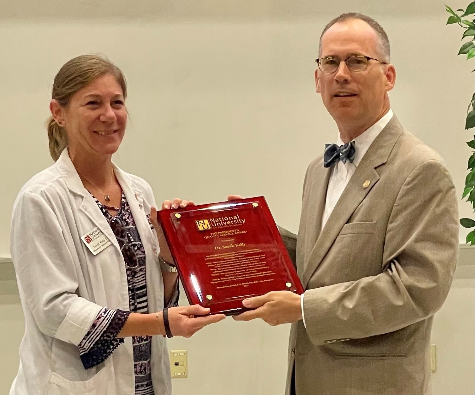 President Joseph P.D. Stiefel, MS, EdD, DC, presents Sarah Kelly, DC ’99, MSACP ’21, Assistant Professor of Clinical Sciences at NUHS-Florida, with the President’s Quality Service Award. 