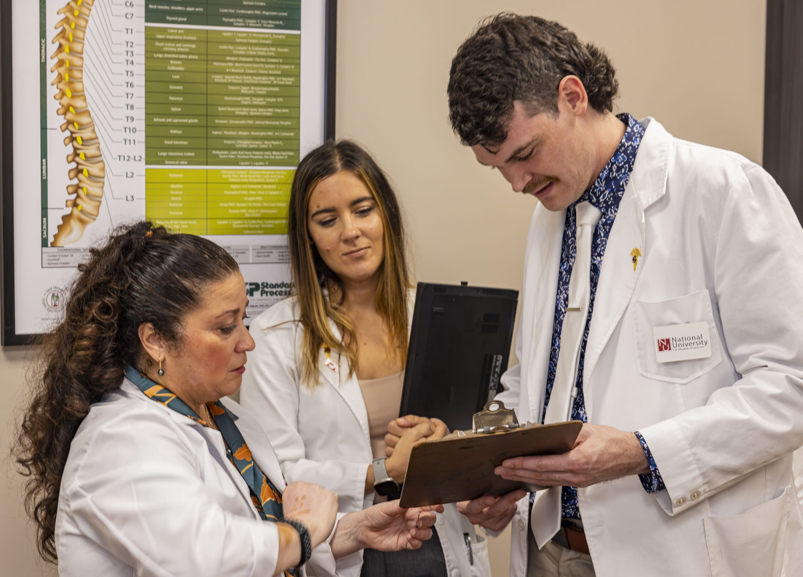 Female DC clinician with male and female interns in clinic setting