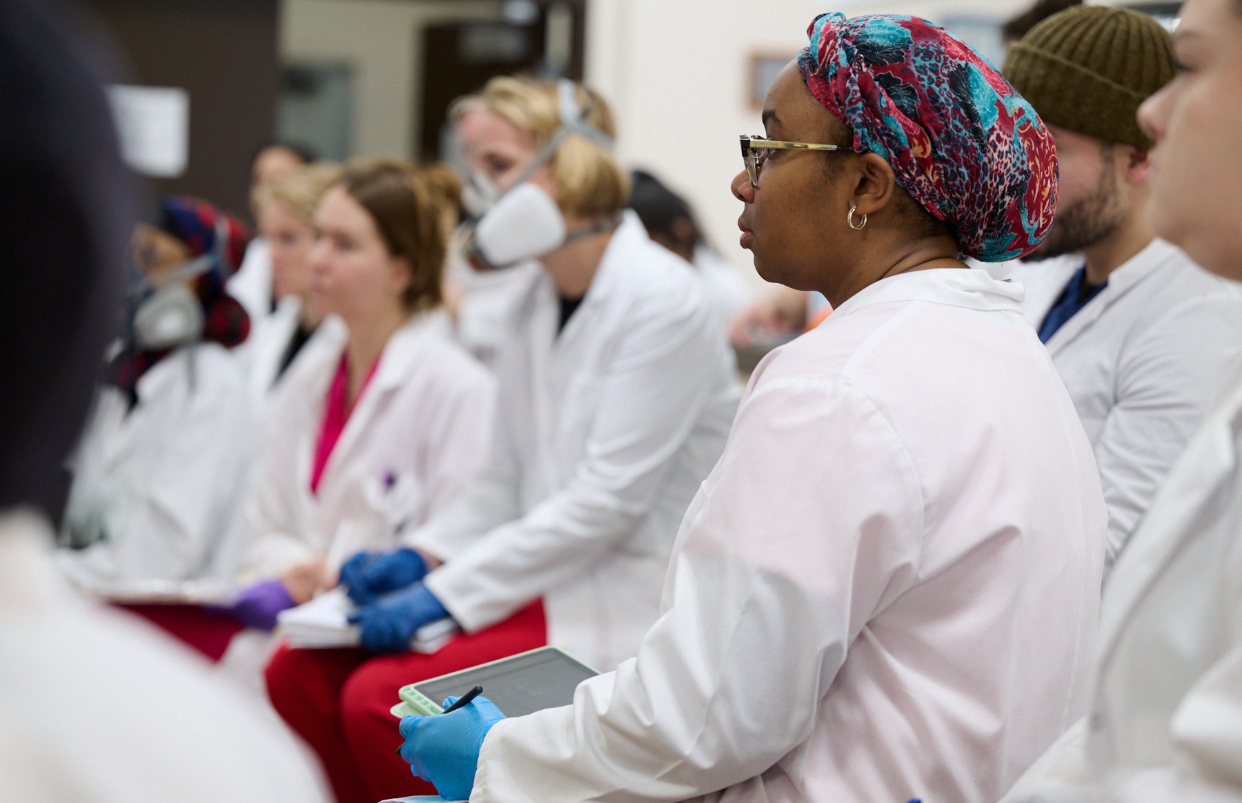 NUHS students in lab coats in anatomy lecture