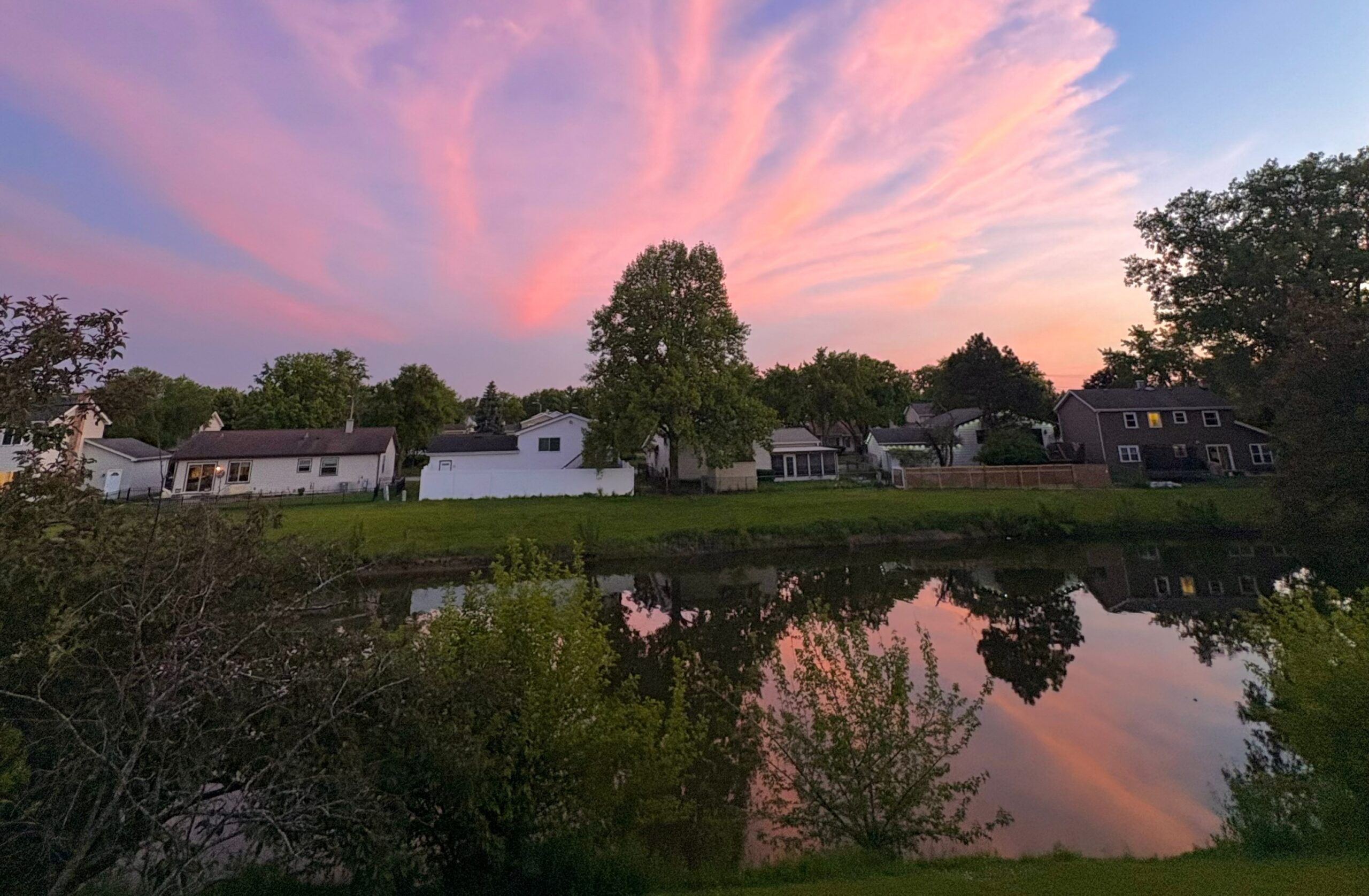 Late spring sunset over homes and lake