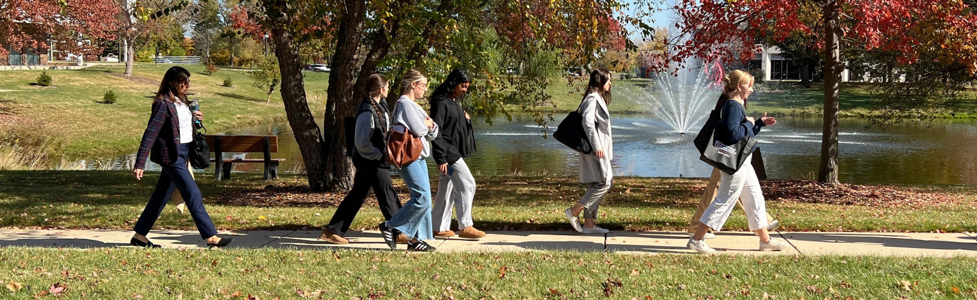 students visiting in fall, walking on campus