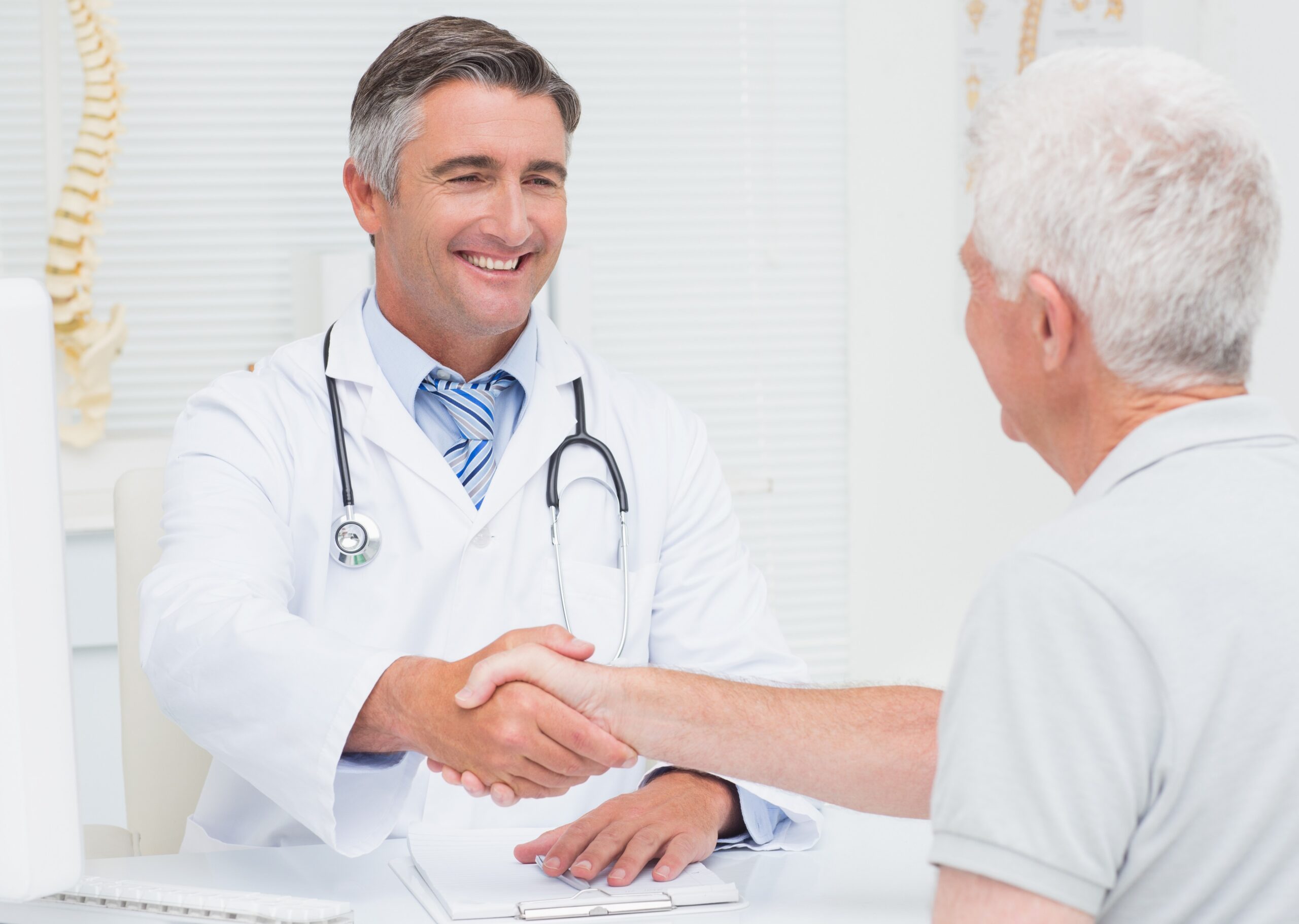 Male doctor greeting male patient