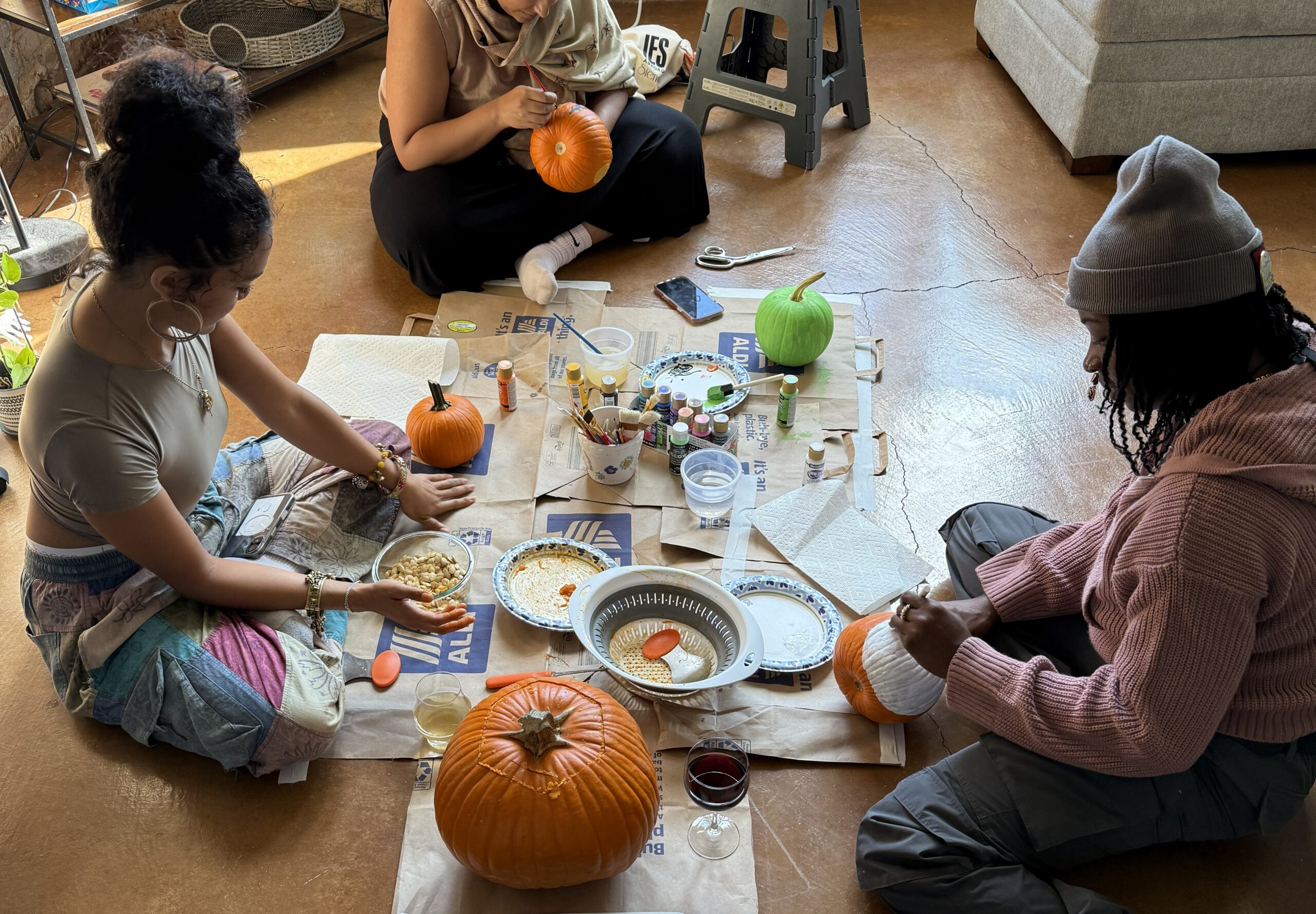 Three young ladies creating Halloween crafts