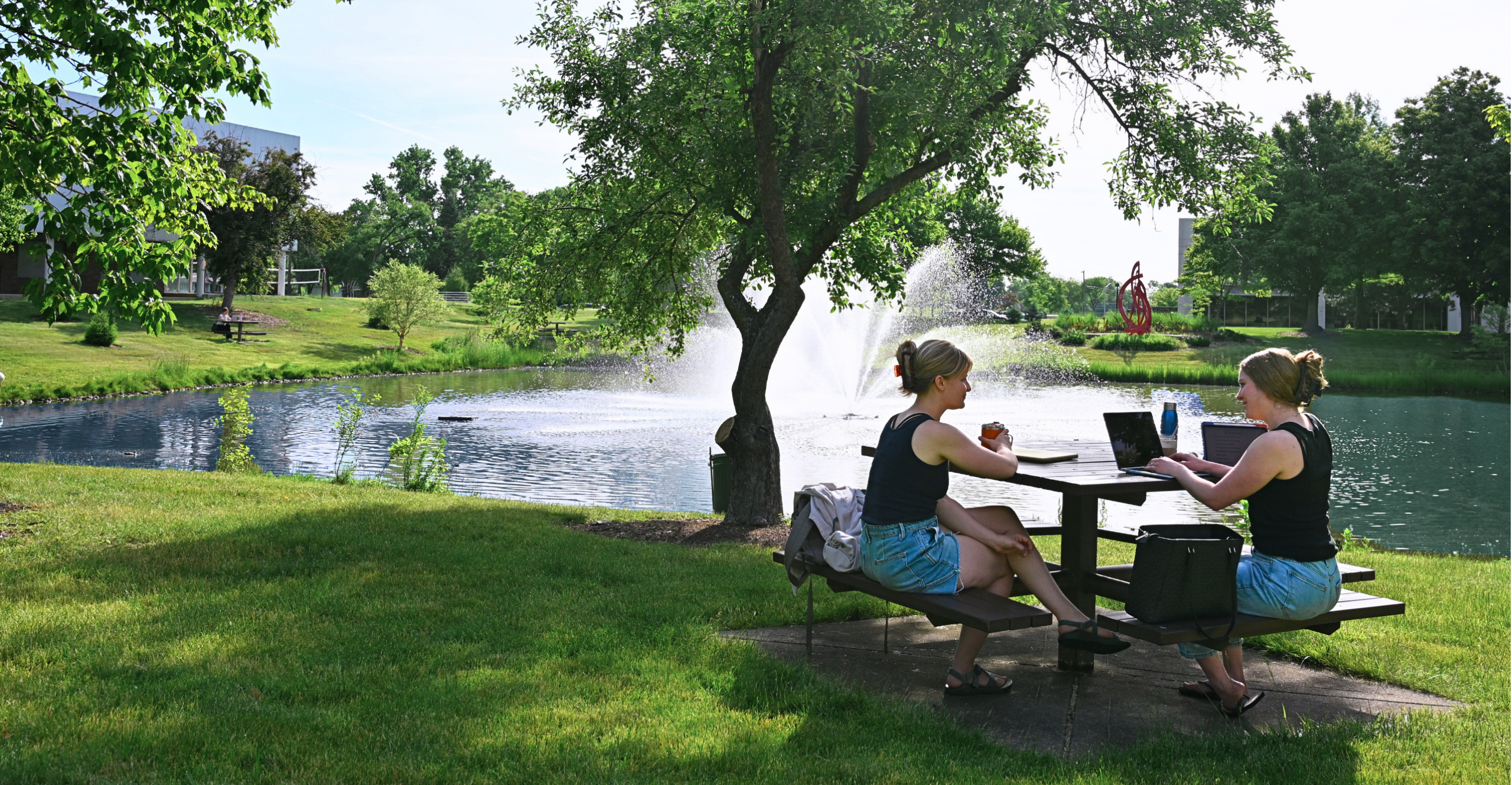Students studying by lake Janse