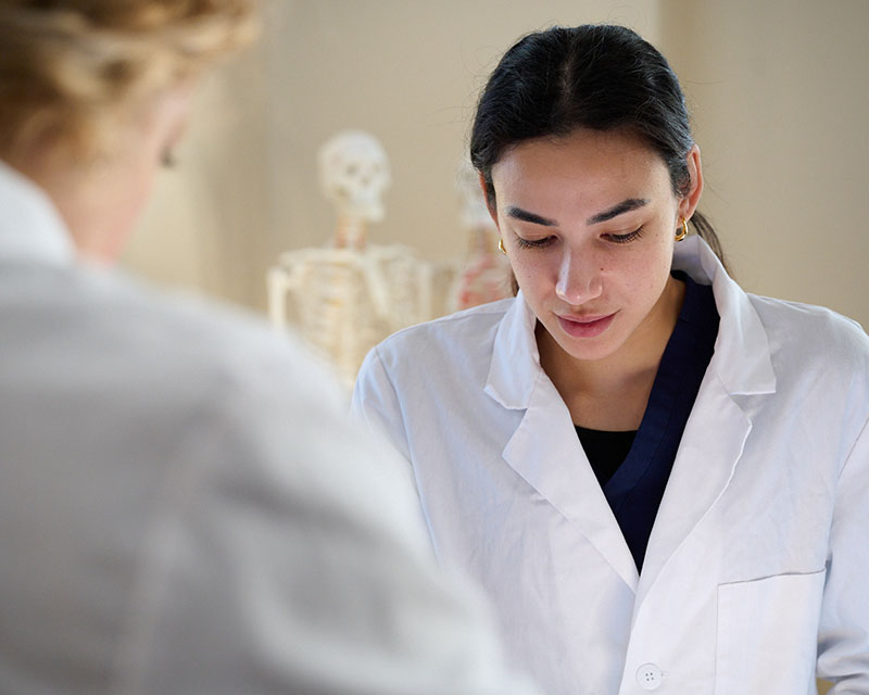 student working in lab with faculty