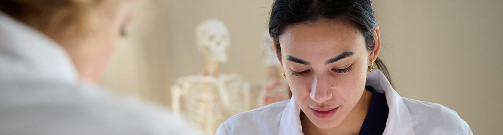 student working in the lab with faculty