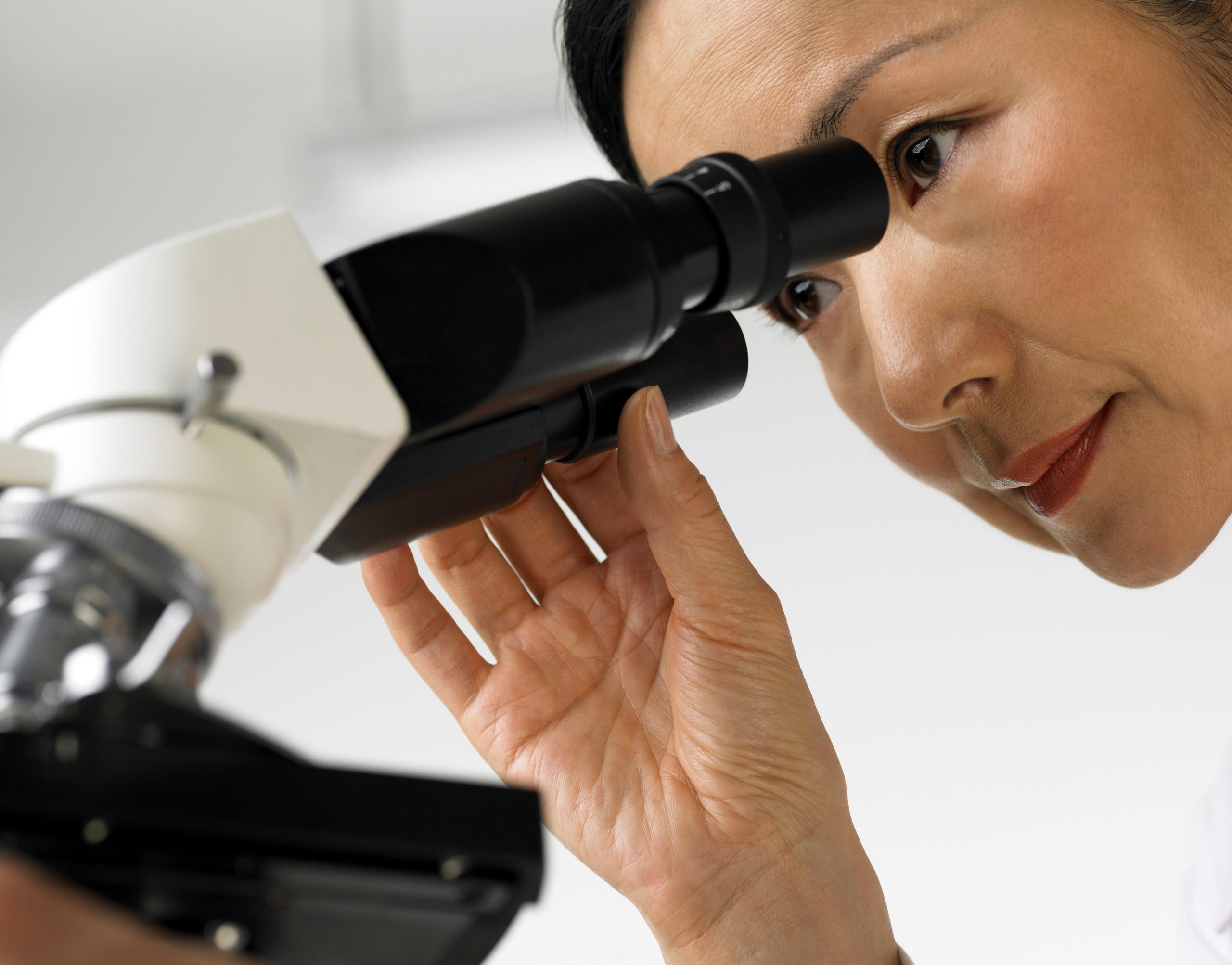 asian woman doctor looking in microscope.jpg