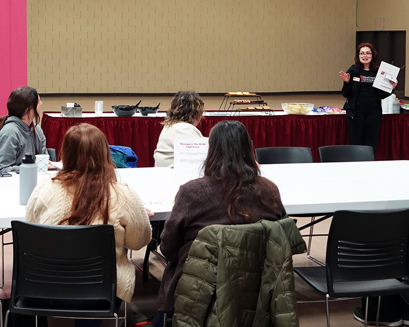 admissions staff meeting with students at visit event